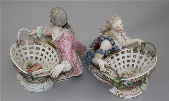 A pair of English porcelain figural sweetmeat dishes, mid 19th century, after the Meissen originals, length 29cm, restorations